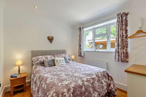 a bedroom with a bed and a window at 2 Bed in Godshill oc-78573 in Godshill