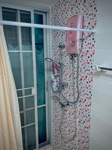 a pink shower in a bathroom with a curtain at Cozy Poolside Condo Near BTS All Amenities in Sathani Ban Hua Mak