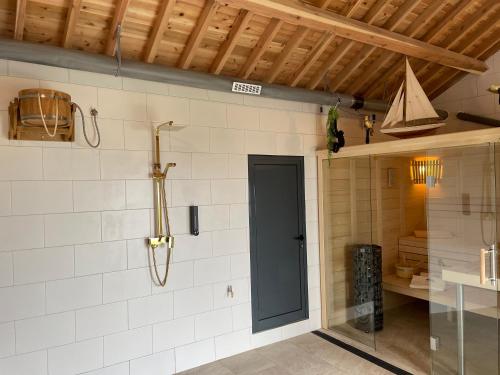 a kitchen with white tiled walls and a glass door at CasaBelaVista II in Pedreira