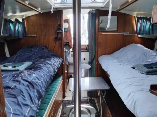a small room with two beds and a table in it at Face à la Mer in Perros-Guirec