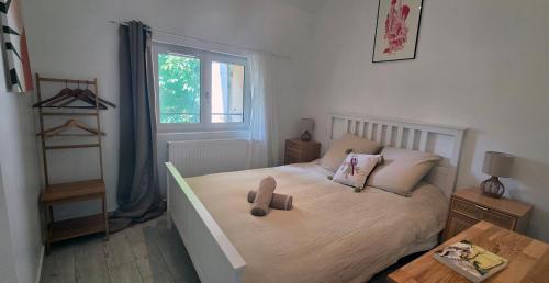 a bedroom with a bed with a wooden doll on it at Maison de la Craffe in Francs
