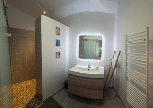 a bathroom with a sink and a mirror at Maison de la Craffe in Francs