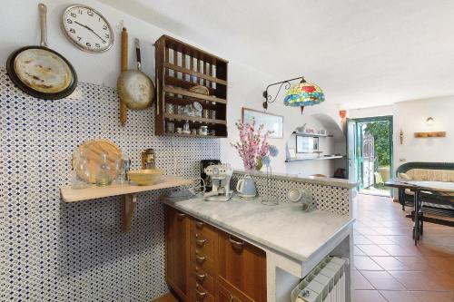 a kitchen with a counter and a clock on the wall at Villa Ponzio in Genoa