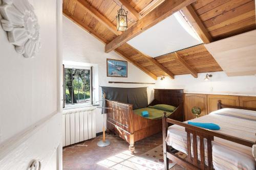 a room with a bed and a table and a window at Villa Ponzio in Genoa