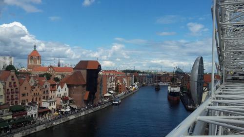 a view of a river with buildings and a city at Hotel Hanza in Gdańsk