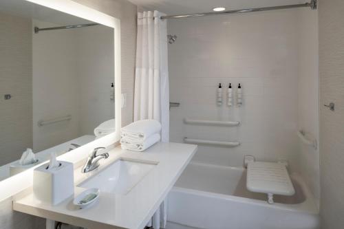 a white bathroom with a sink and a shower at Fairfield Inn & Suites by Marriott Charlotte Uptown in Charlotte