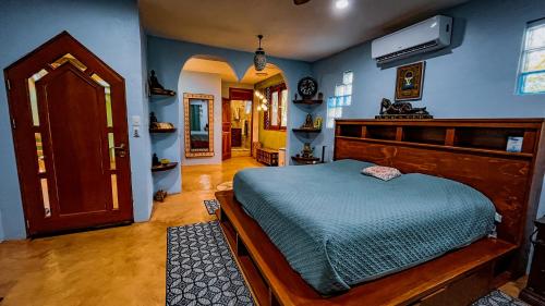 a bedroom with a bed in a room with blue walls at Kaan Serenity Sanctuary in Coba