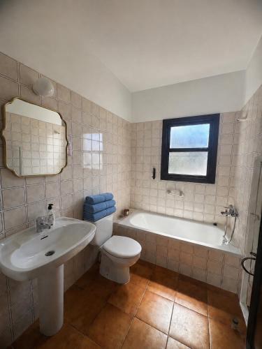a bathroom with a sink and a toilet and a tub at Sa Cala C16 in Cala Morell
