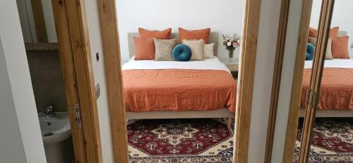 a bedroom with two beds and a mirror at Apartment in recent residence in Monastir