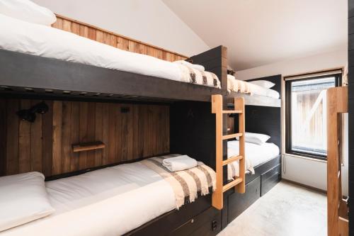 a bedroom with two bunk beds and a window at Hostal Boutique Factoria Patagonia in Puerto Natales