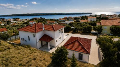 an aerial view of a white house with red roofs at Villa Lumia in Banjol
