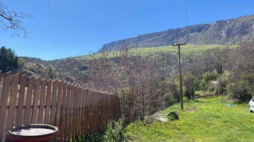a fence in a field with a mountain in the background at Kuca Lula Stara planina in Pirot