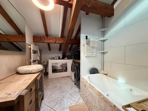 a large bathroom with a tub and a sink at La maison d'Artzamendi in Louhossoa