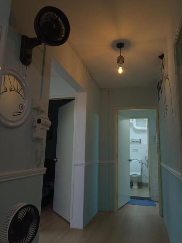 a room with a bathroom with a toilet and a door at Kluang Countryside Scenery NO LIFT SECOND FLOOR#NETFLIX#RETRO GAME in Kluang