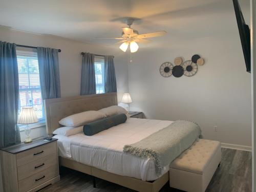 a bedroom with a bed and a ceiling fan at School Village Walk-in shower and jetted tub in Elizabethtown