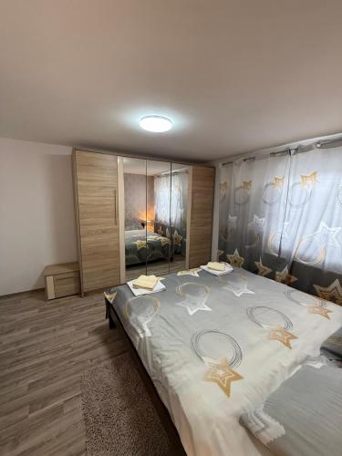 a bedroom with a large bed with stars on it at Deskom Stan na dan in Despotovac