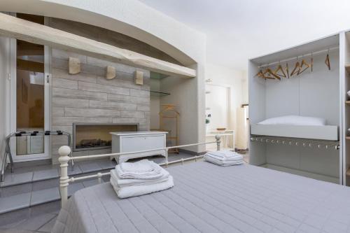 a bedroom with a bed and a fireplace at Villa Thalissa by Perle di Puglia in Taranto