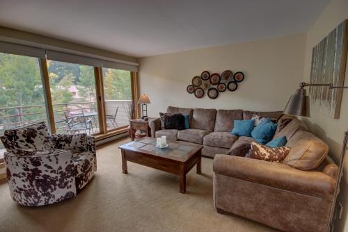 a living room with a couch and two chairs at Ski Run 201 by SummitCove Lodging in Colorado in Keystone