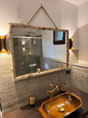 a bathroom with a wooden sink and a mirror at Villa Siana in Bran