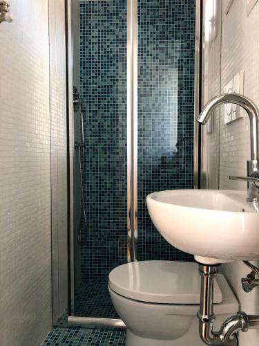 a bathroom with a sink and a toilet and a shower at B&B Porta Girone in Civitanova Alta