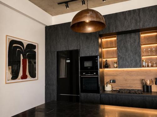 a kitchen with a black counter top and a microwave at Luxury Villa #1 in Tabakhmela