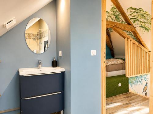 a bathroom with a sink and a bunk bed at Le Doux Nid in Chanaz