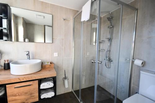 a bathroom with a sink and a shower at Dorana Hotel in Kyrenia