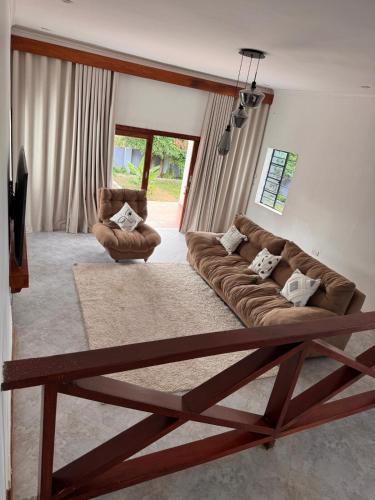 a living room with a couch and a chair at 3 bedroom house with a mountain view in Mbeya
