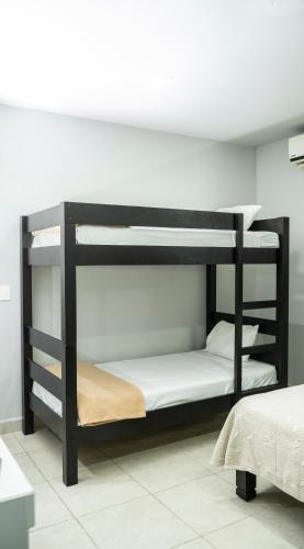 a black bunk bed in a room at Hotel Tampico Express in Ciudad Madero
