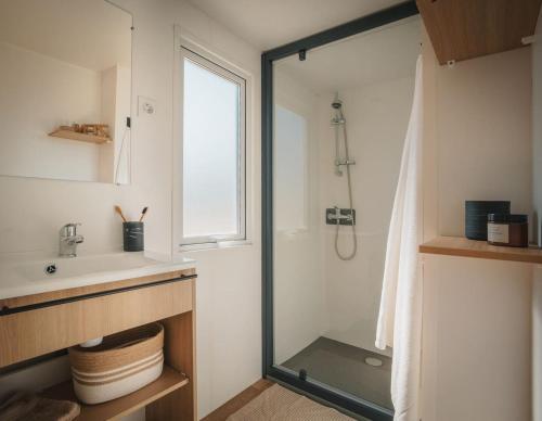 a bathroom with a shower and a sink at Camping Cabestan in Bretignolles-sur-Mer
