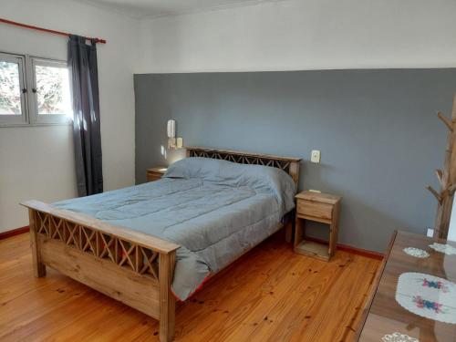 a bedroom with a large bed and a wooden floor at Temporario Avenida in Rafaela