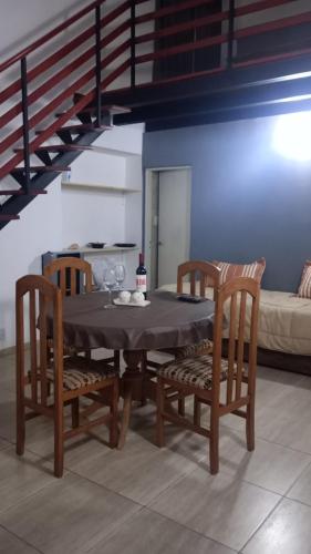 a dining room with a table and two chairs at Temporario Avenida in Rafaela
