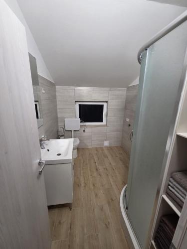 a small bathroom with a sink and a toilet at Apartma Pri Stevotu in Deskle