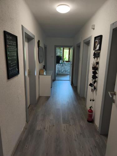 a hallway of a house with wooden floors and a chalkboard at Quaint Room in Modern Flat in Innsbruck