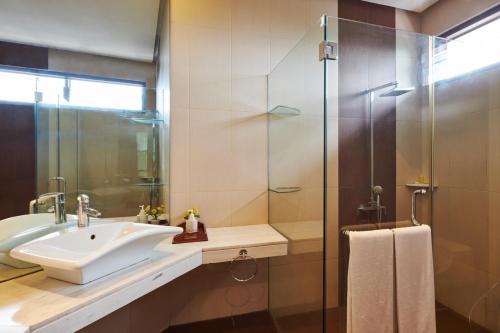 a bathroom with a sink and a glass shower at Morning Glory Mountain View Villa 4 Bedrooms With a Private Heated Swimming Pool in Bandung