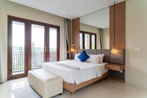 a bedroom with a large bed and a large window at Morning Glory Mountain View Villa 4 Bedrooms With a Private Heated Swimming Pool in Bandung