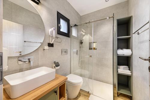 a bathroom with a sink and a shower at Selva Cabins in Zărneşti