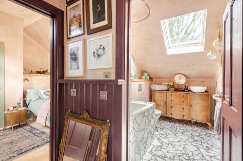 a bathroom with a mirror and a sink in it at The Wood Wing Suite at Bellspool in Peebles