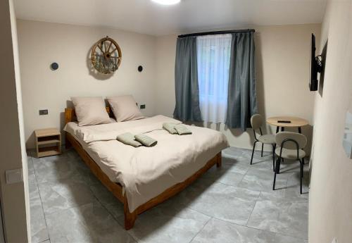 a bedroom with a bed with two pillows on it at Apartments House Pylypets in Pilipets