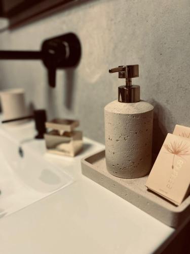 a bathroom sink with a faucet and a book at Apartmán GREEN in Vysoké Mýto
