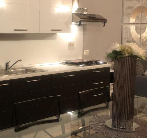 a kitchen with a sink and a counter top at Villa Giotto Luxury Suite & Apartments in Mestre