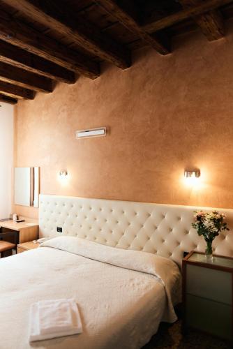 a bedroom with a large bed in a room at Hotel Roma in Cittadella