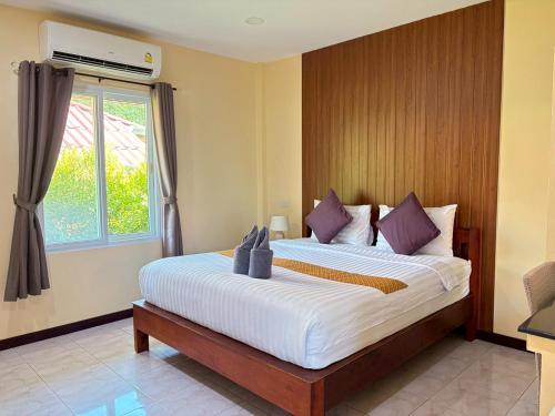 a bedroom with a large bed with a window at Rimlay Bay View 2 in Ko Yao Noi