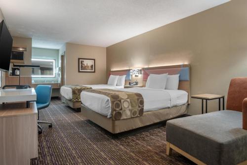 a hotel room with two beds and a flat screen tv at Best Western Vicksburg in Vicksburg