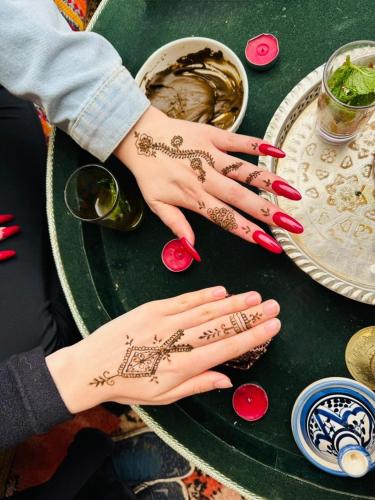 a woman with henna on her hands on a table at Dar Oussama in Rabat