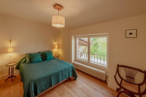 a bedroom with a bed and a window at Vila Cabanes 46 in Le Montat