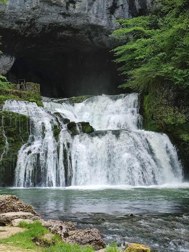 a waterfall in the middle of a river at Chambre chez Danuta in Champagnole