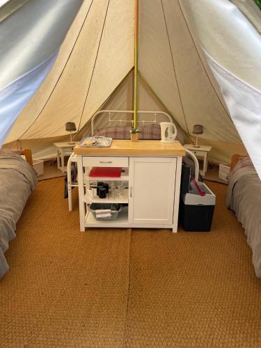 a tent with a table in the middle of it at Glamping at Camping La Source in Saint-Pierre-dʼArgençon