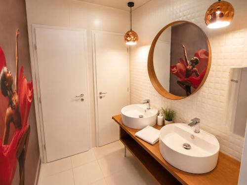 a bathroom with two sinks and a mirror at Hévíz Springs - Kehidakustány in Kehidakustány