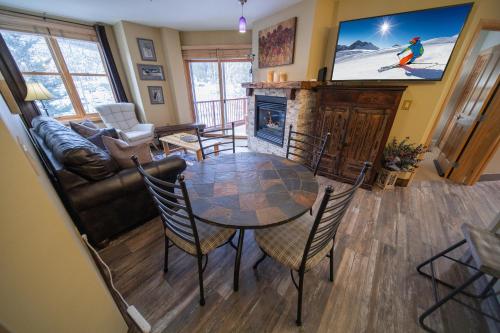 a living room with a table and a fireplace at Silver Mill 8228 by SummitCove Lodging in Colorado in Keystone